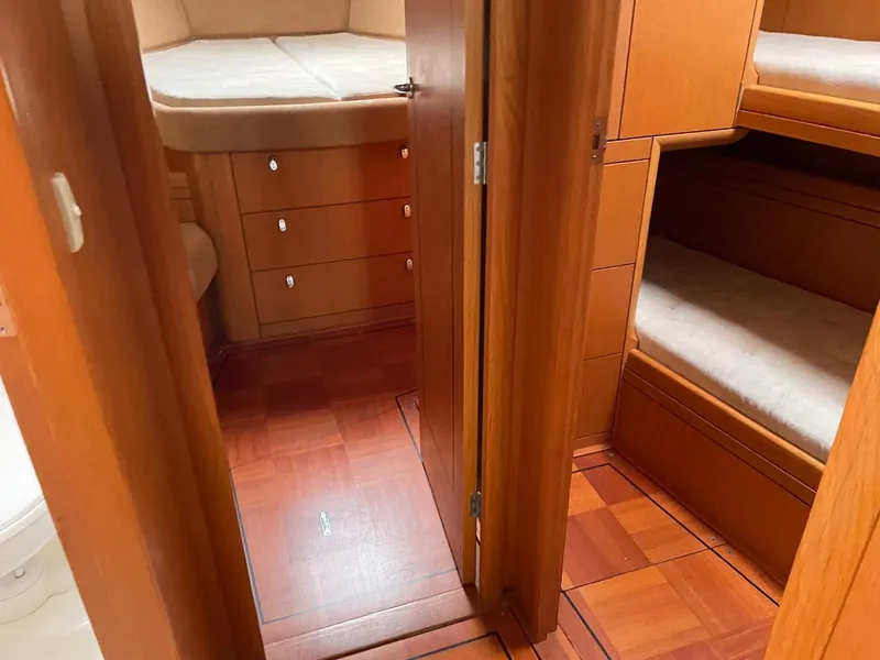 Slide: The Image of Interior of 2003 Oyster 53 yacht with wooden cabinetry and cozy sleeping quarters. - 30