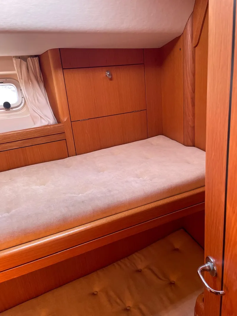 Slide: The Image of Cozy cabin interior of 2003 Oyster 53 yacht with wooden furnishings. - 31