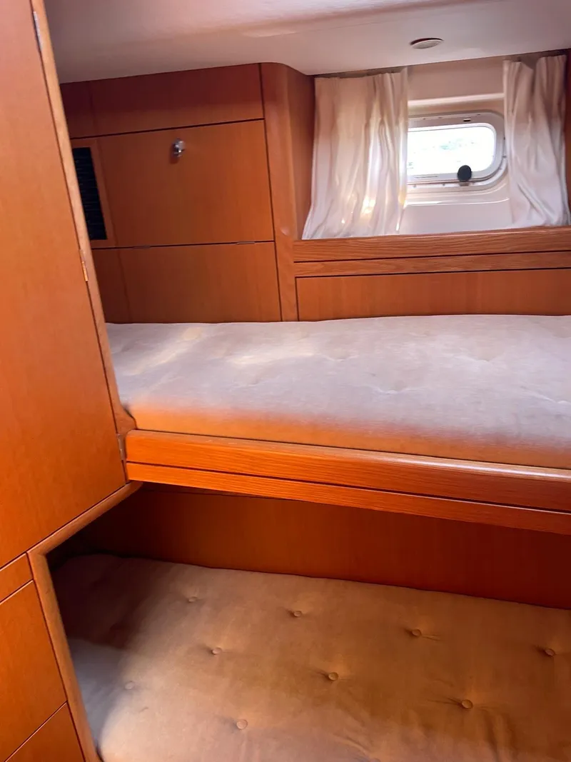 Slide: The Image of Interior cabin of 2003 Oyster 53 yacht with wooden finish and bunk beds. - 32