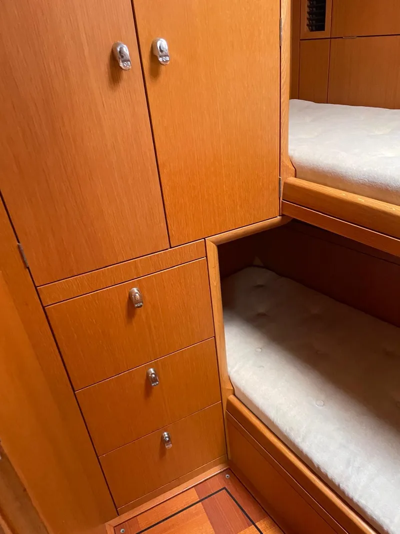 Slide: The Image of Wooden interior of 2003 Oyster 53 yacht with bunk beds and storage. - 33