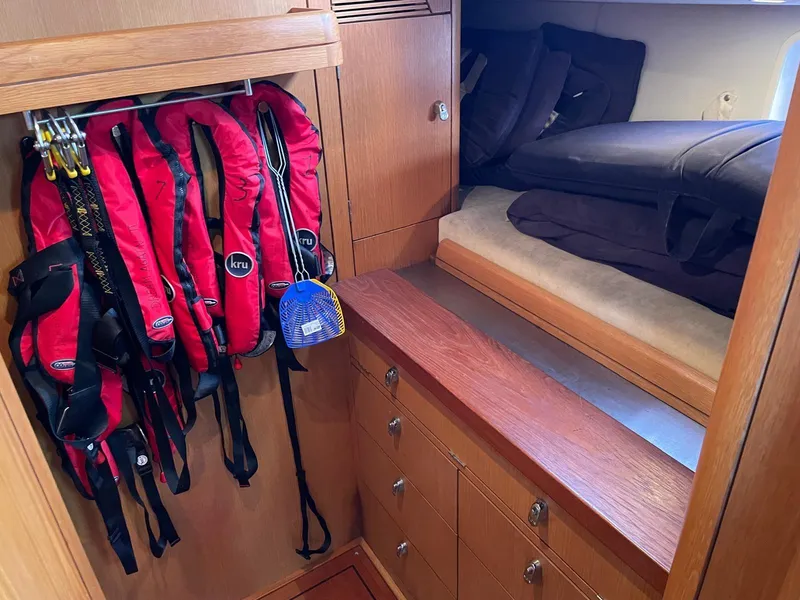 Slide: The Image of Interior of 2003 Oyster 53 yacht with life jackets and cozy sleeping area. - 35