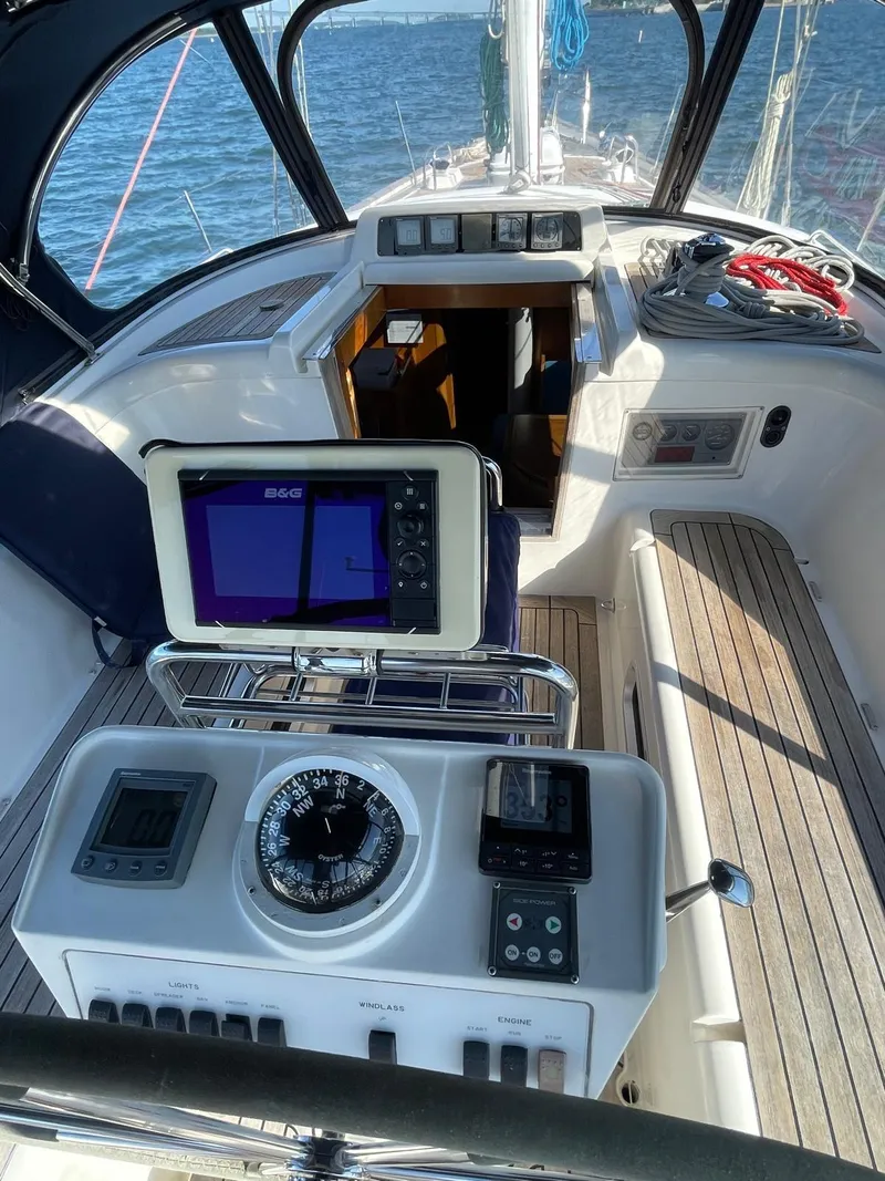 Slide: The Image of 2003 Oyster 53 yacht cockpit with navigation equipment and wooden deck. - 5