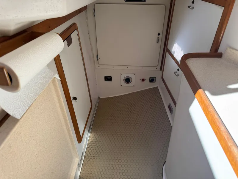 Slide: The Image of Interior of 1996 Catalina 42-2P MK II sailboat, featuring storage compartments and a compact design. - 6