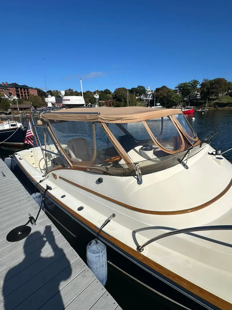 Slide: The Image of 1997 Hinckley T29 Express docked, showcasing classic design and elegant lines. - 10