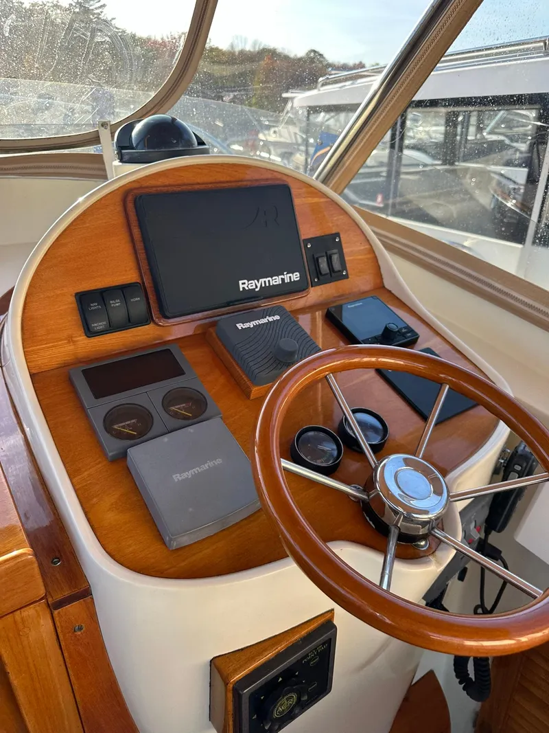 Slide: The Image of 1997 Hinckley T29 Express helm with Raymarine electronics and wooden steering wheel. - 26