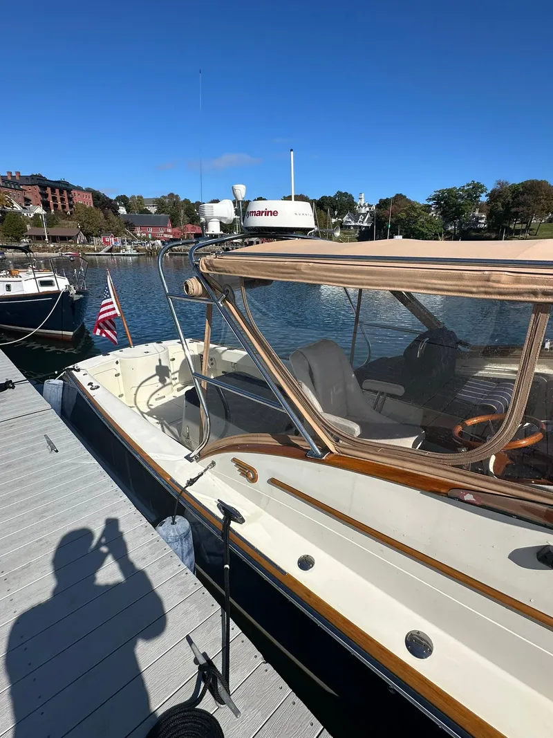 Slide: The Image of 1997 Hinckley T29 Express docked at marina under clear blue sky. - 12