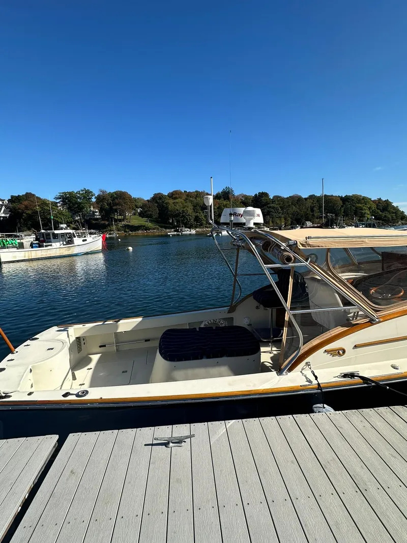 Slide: The Image of 1997 Hinckley T29 Express docked by a scenic waterfront under clear blue skies. - 17