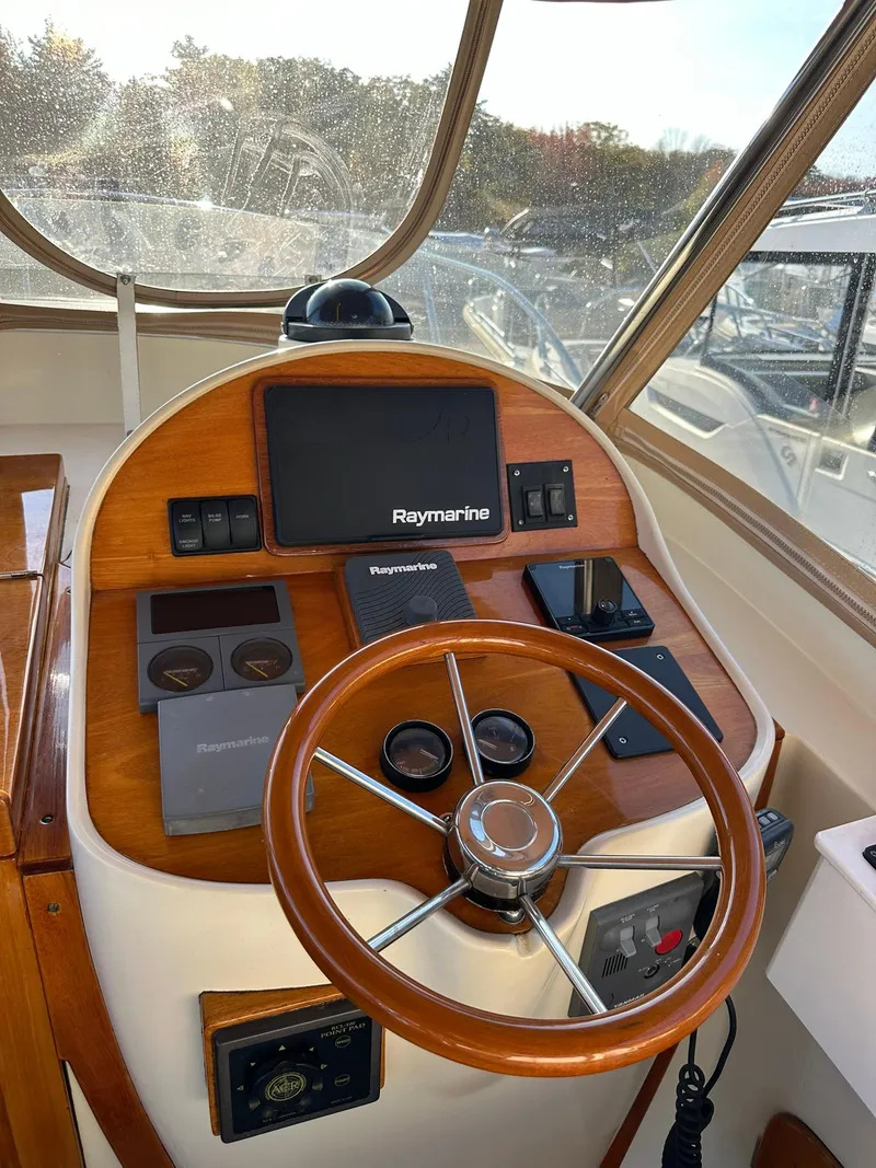 Slide: The Image of 1997 Hinckley T29 Express helm with Raymarine navigation system and wooden steering wheel. - 24