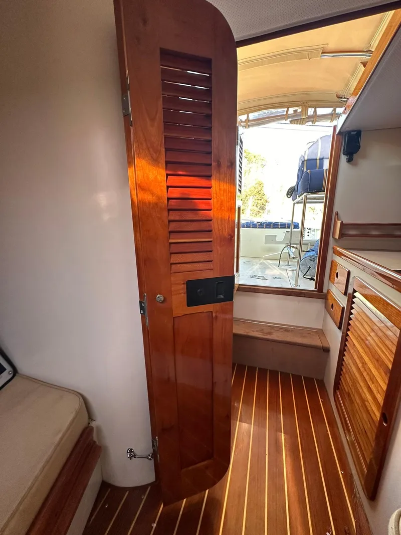 Slide: The Image of Interior of 1997 Hinckley T29 Express boat with wooden door and flooring. - 33