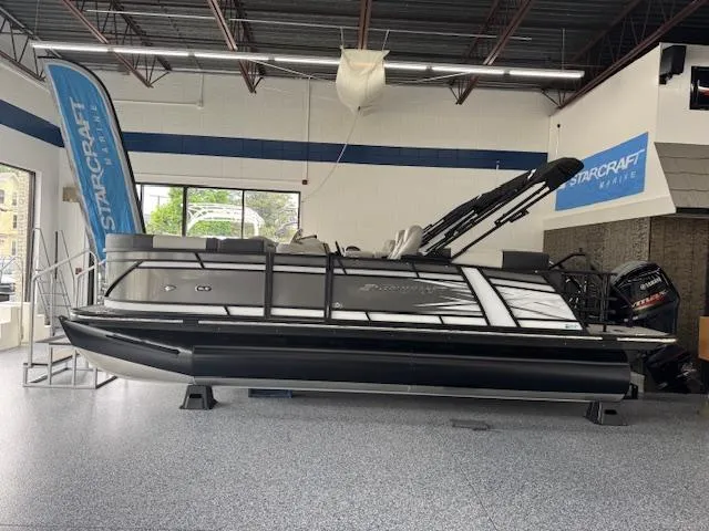 Slide: The Image of 2025 Starcraft SLS 1 pontoon boat displayed indoors with sleek design and modern features. - 1