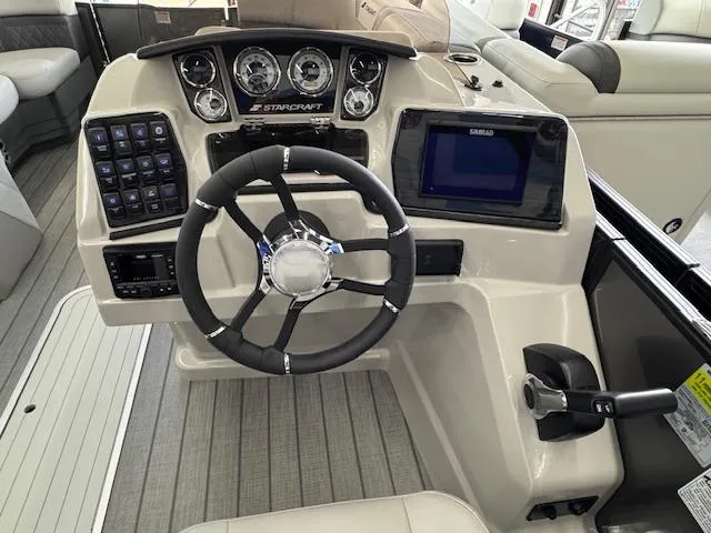 Slide: The Image of 2025 Starcraft SLS 1 boat dashboard with steering wheel and control panel. - 11