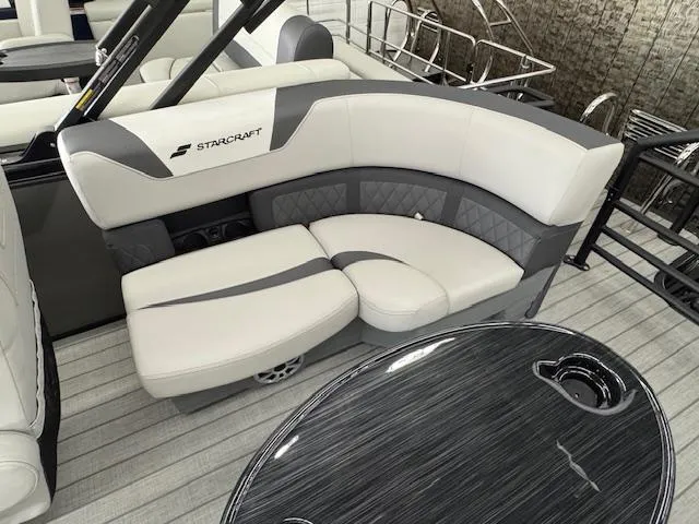Slide: The Image of 2025 Starcraft SLS 1 boat interior with gray and white seating and sleek table design. - 18