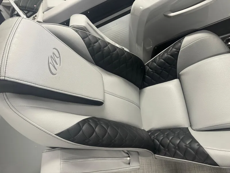 Slide: The Image of 2025 Manitou LX boat seat with black and gray quilted upholstery. - 11