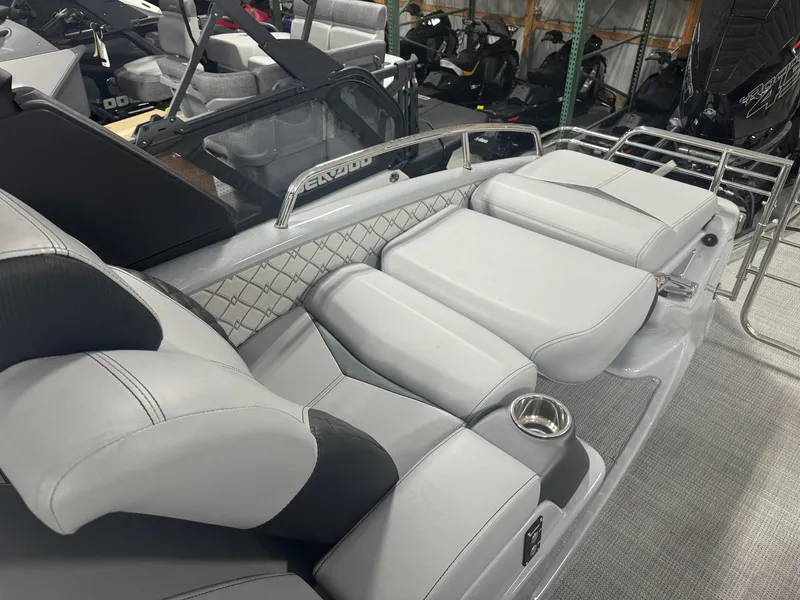 Slide: The Image of 2025 Manitou LX boat interior with luxurious gray seating and modern design. - 12