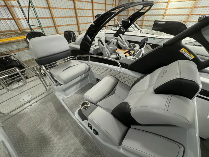 Slide: The Image of 2025 Manitou LX boat interior with luxurious seating and modern design. - 14
