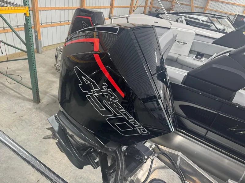 Slide: The Image of 2025 Manitou LX boat with powerful Racing 450 engine in storage facility. - 18