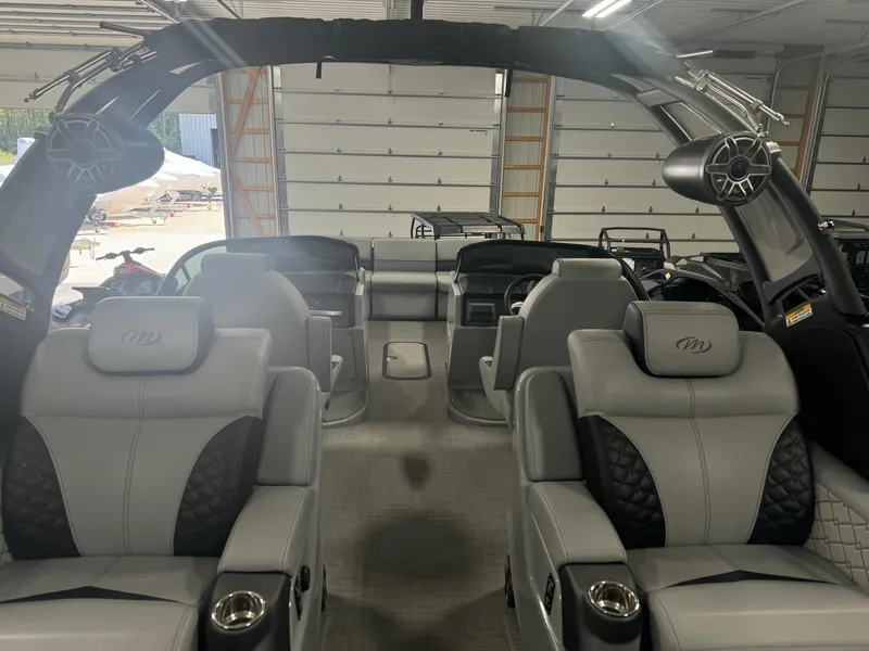 Slide: The Image of Interior of 2025 Manitou LX boat with luxurious seating and modern design. - 21