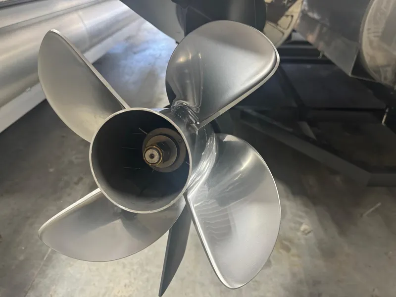 Slide: The Image of Close-up of a 2025 Manitou LX boat propeller in a workshop setting. - 25