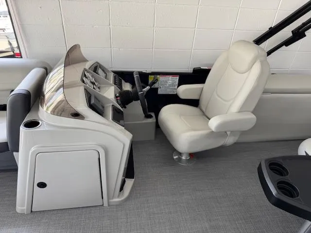 Slide: The Image of 2025 Starcraft EXS 3 Q boat interior with modern helm and comfortable captain's chair. - 10