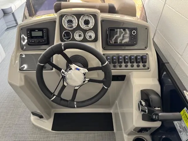 Slide: The Image of Steering console of 2025 Starcraft EXS 3 Q boat with modern controls and gauges. - 11
