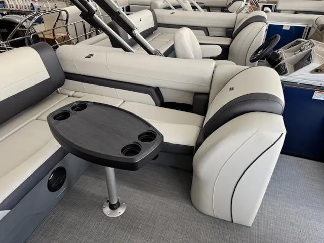 Slide: The Image of 2025 Starcraft EXS 3 Q boat interior with plush seating and a central table. - 12