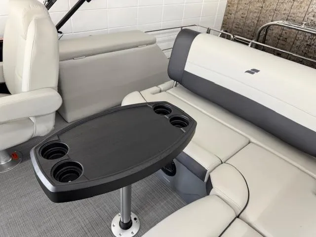 Slide: The Image of Luxurious seating area in 2025 Starcraft EXS 3 Q boat with cup holders. - 14