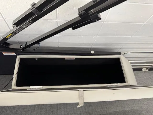Slide: The Image of Open storage compartment of 2025 Starcraft EXS 3 Q boat. - 16