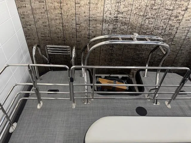 Slide: The Image of Starcraft EXS 3 Q 2025 boat deck with metal railings and storage compartment. - 19