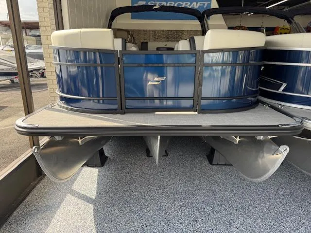 Slide: The Image of 2025 Starcraft EXS 3 Q pontoon boat, blue exterior, showroom display. - 2