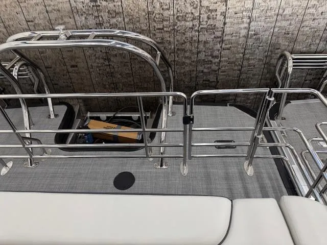 Slide: The Image of 2025 Starcraft EXS 3 Q boat deck with metal railings and seating. - 20