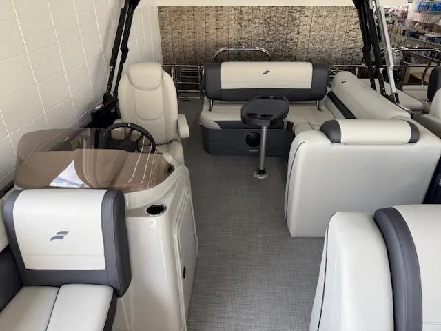 Slide: The Image of 2025 Starcraft EXS 3 Q boat interior with modern seating and steering console. - 9