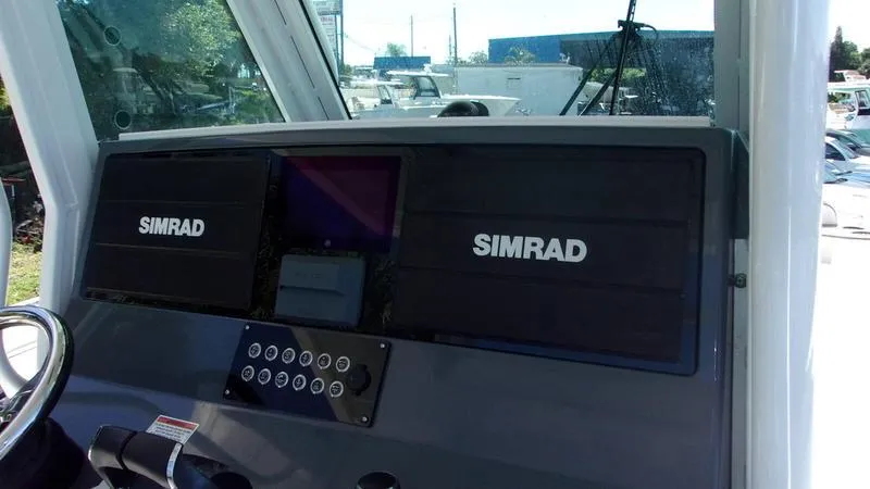 Slide: The Image of 2022 Crevalle 33 CSF Offshore Fishing boat dashboard with Simrad navigation system. - 11