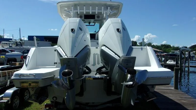 Slide: The Image of 2022 Crevalle 33 CSF Offshore Fishing boat with dual outboard engines at dock. - 17