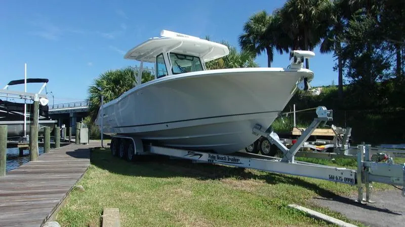 The Image of 2022 Crevalle 33 CSF Offshore Fishing boat on trailer by dock. - 0