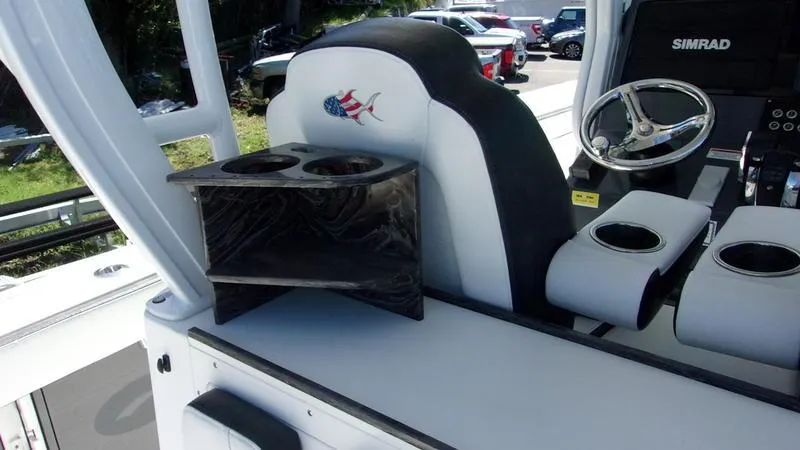 Slide: The Image of 2022 Crevalle 33 CSF Offshore Fishing boat interior with steering wheel and cup holders. - 15
