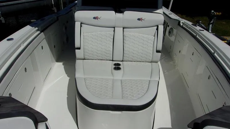 Slide: The Image of 2022 Crevalle 33 CSF Offshore Fishing boat interior with cushioned seating. - 2