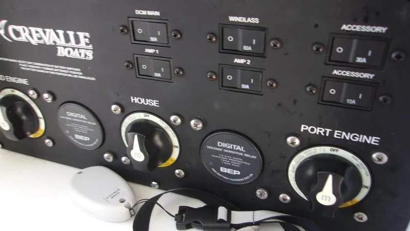 Slide: The Image of Control panel of 2022 Crevalle 33 CSF Offshore Fishing boat with switches and dials. - 26