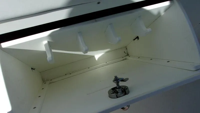 Slide: The Image of Crevalle 33 CSF Offshore Fishing 2022 rod storage compartment, white interior, open view. - 28