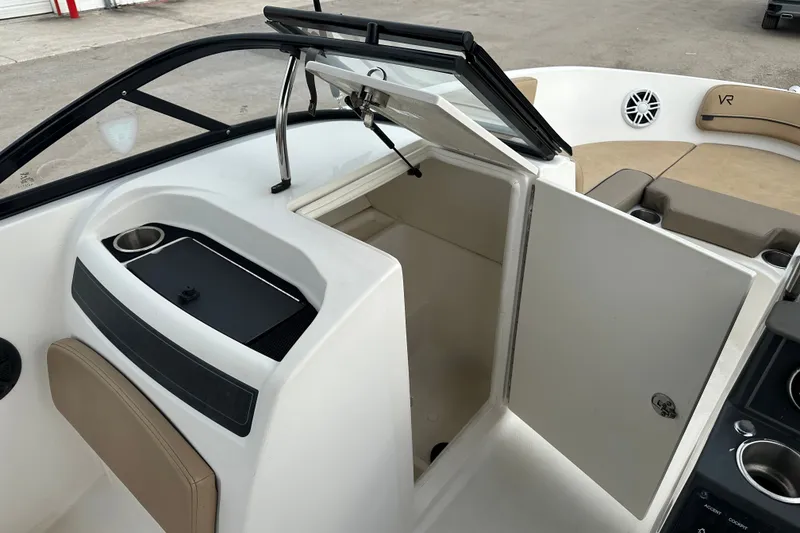 Slide: The Image of 2023 Bayliner VR4 Bowrider OB interior with open storage compartment and seating area. - 12