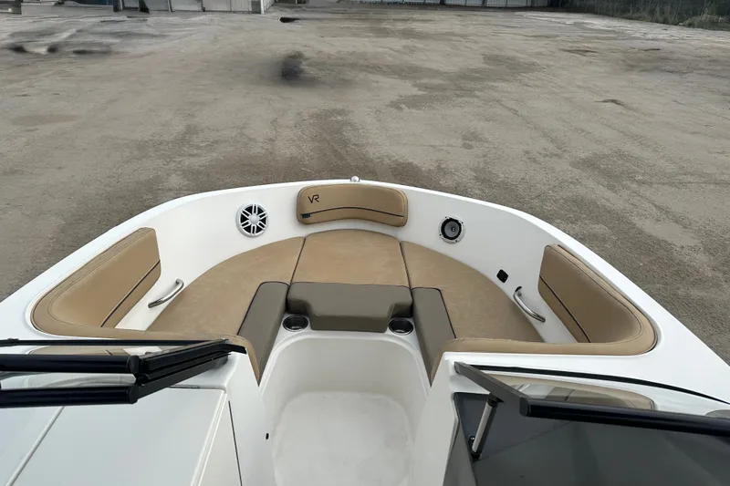 Slide: The Image of 2023 Bayliner VR4 Bowrider OB interior with tan seating and cup holders. - 11