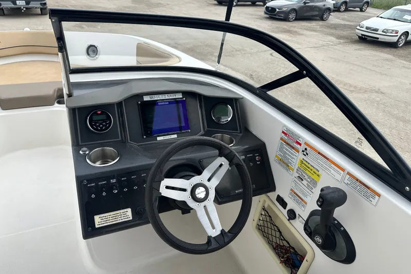 Slide: The Image of 2023 Bayliner VR4 Bowrider OB dashboard with steering wheel and control panel. - 5