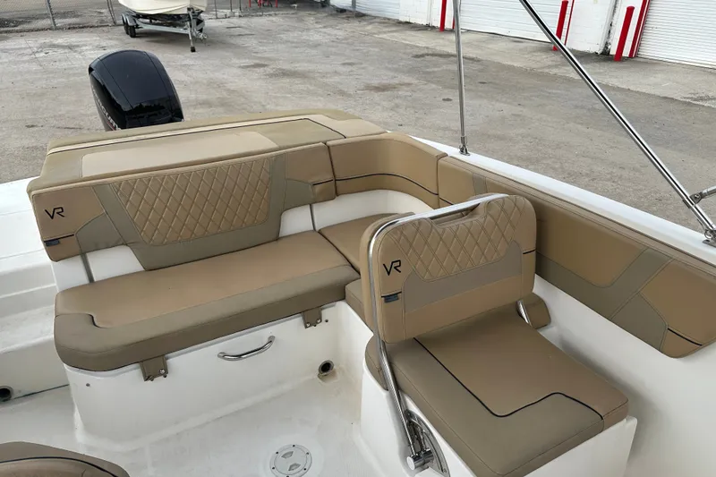 Slide: The Image of 2023 Bayliner VR4 Bowrider OB interior with tan seating and diamond stitching. - 9