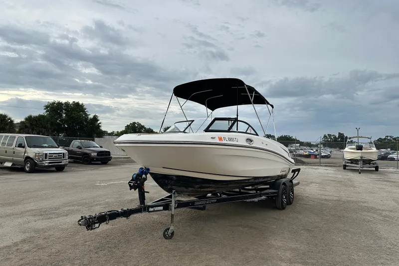 The Image of 2023 Bayliner VR4 Bowrider OB on trailer in parking lot under cloudy sky. - 0