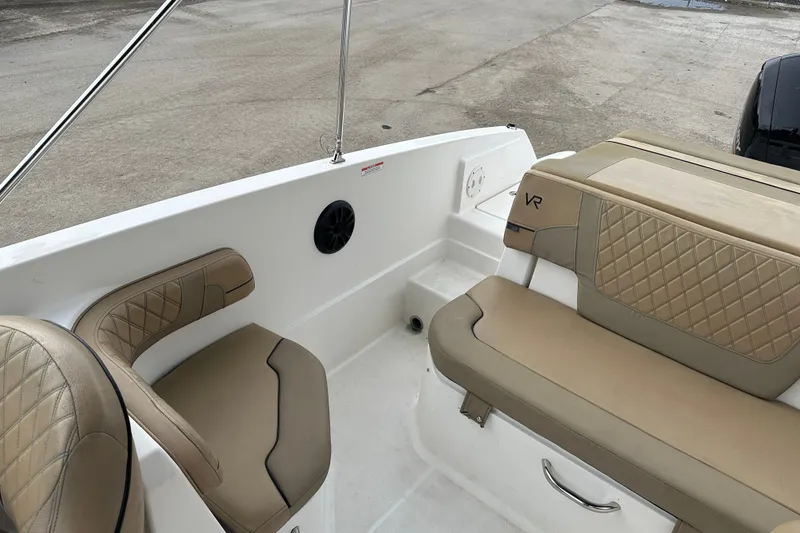 Slide: The Image of 2023 Bayliner VR4 Bowrider OB interior with tan seating and sleek design. - 10