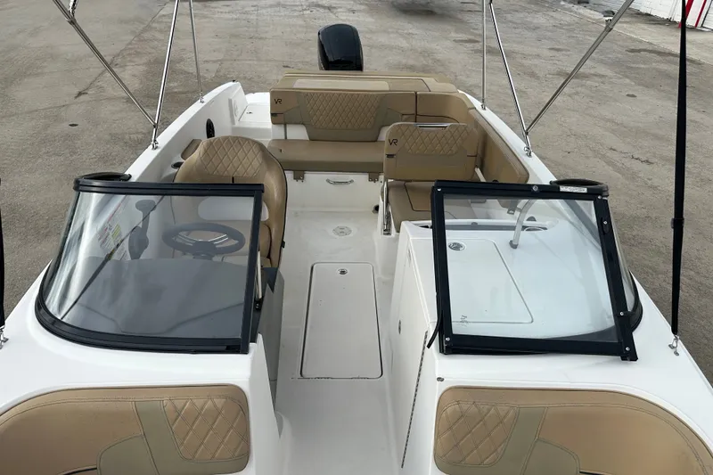 Slide: The Image of 2023 Bayliner VR4 Bowrider OB interior with tan seating and windshield. - 8