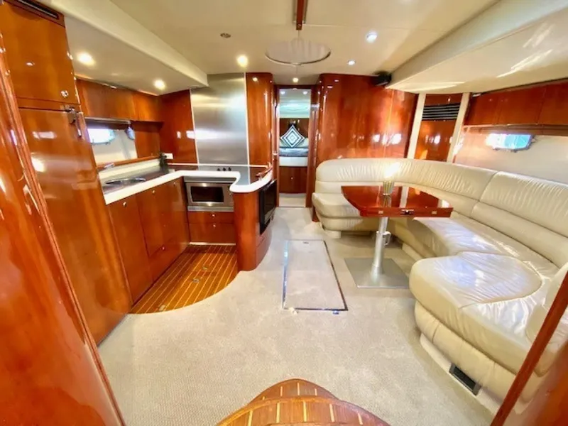 Slide: The Image of Luxurious 2007 Fairline Targa 52 yacht interior with kitchen and seating area. - 11