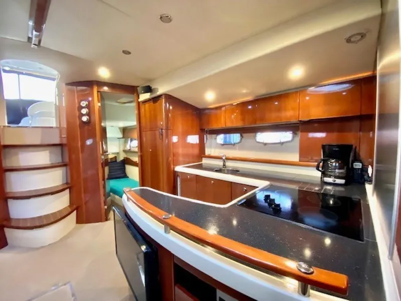 Slide: The Image of Luxurious 2007 Fairline Targa 52 yacht interior with modern kitchen and elegant wood finishes. - 13