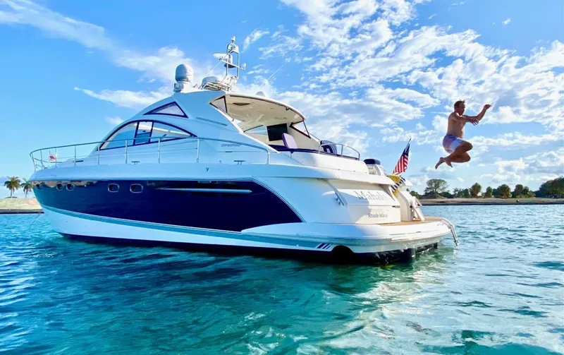Slide: The Image of 2007 Fairline Targa 52 yacht with person jumping into clear blue water. - 2