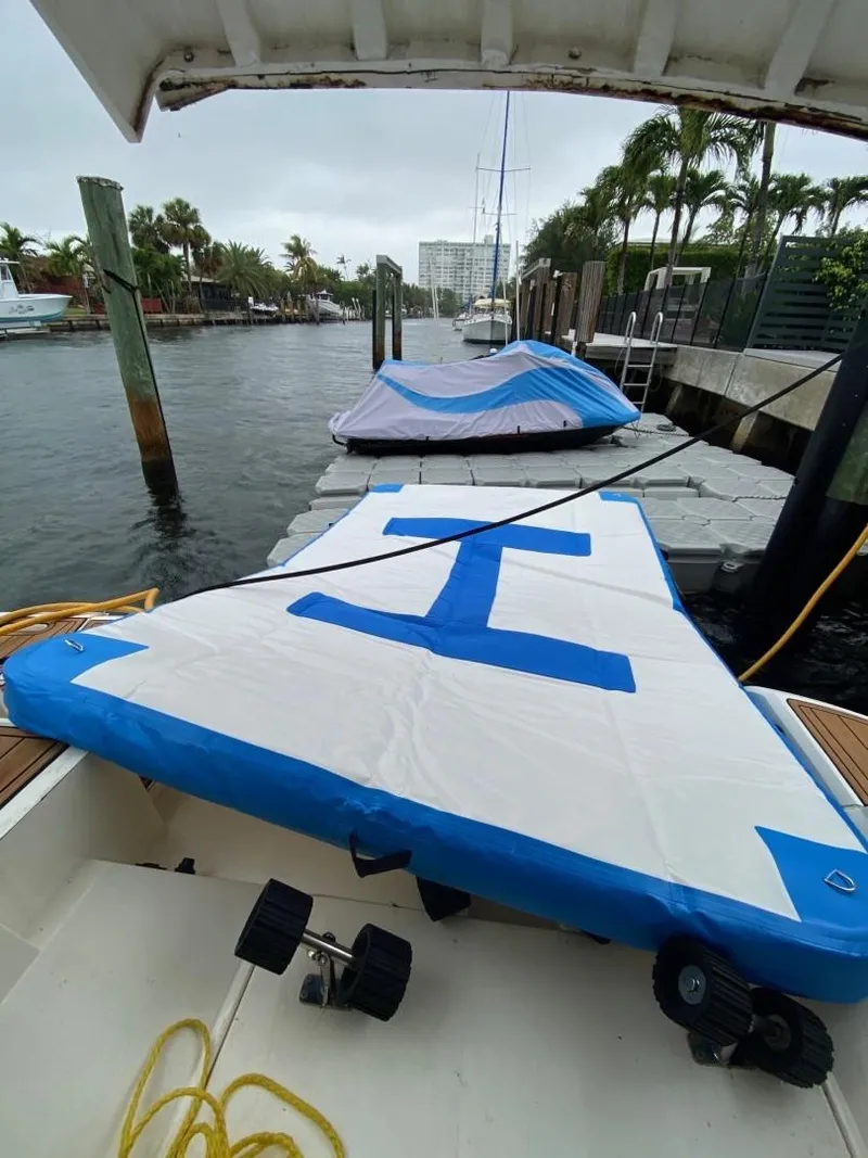 Slide: The Image of 2007 Fairline Targa 52 yacht docked, covered with protective tarps, in a marina setting. - 21