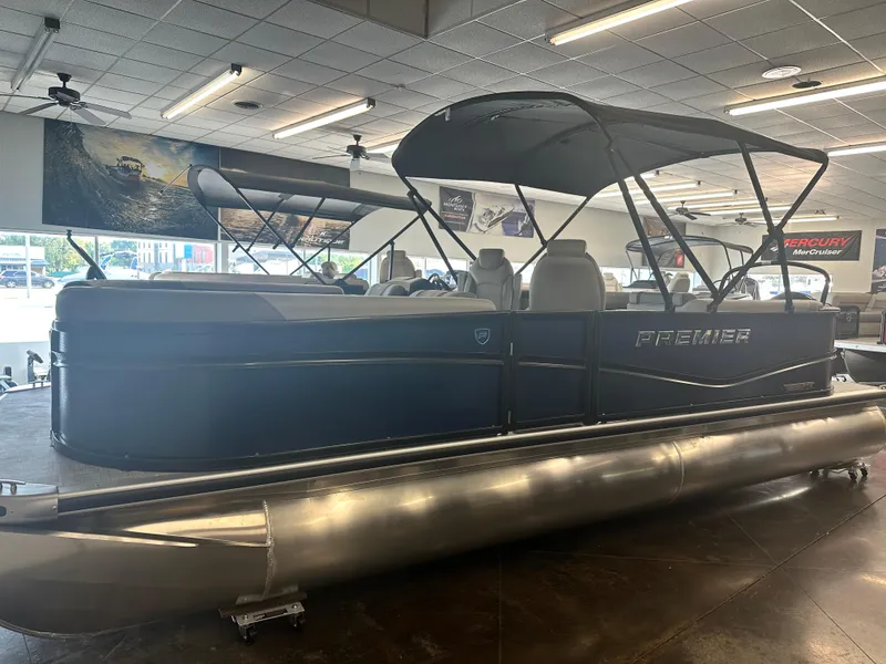 The Image of 2025 Premier 220 Sunscape pontoon boat displayed in a showroom. - 1
